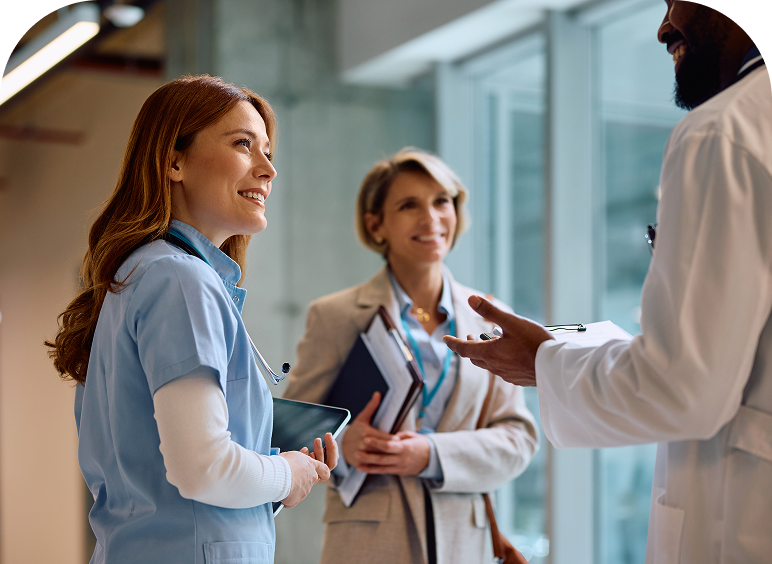 Medical professionals discussing in a hospital corridor.